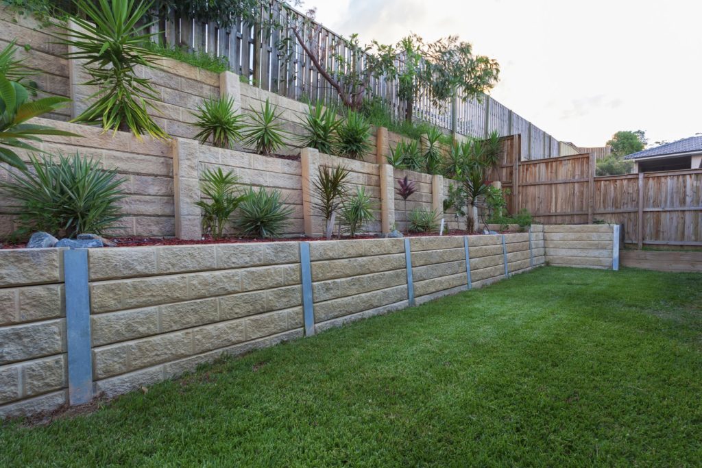 Multi level retaing wall with plants in backyard