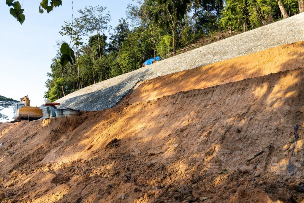 Slope retention construction work being carried out to manage landslide in highland