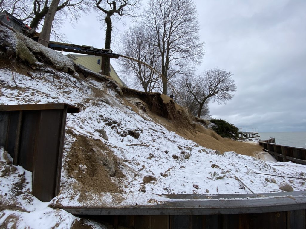 Sand being placed behind seawall