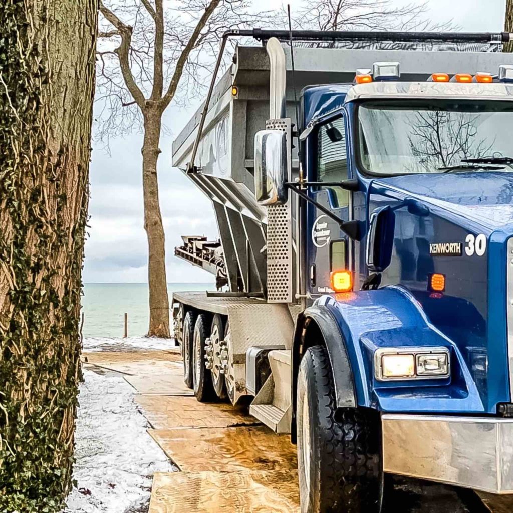 Stone slinger truck for backfill