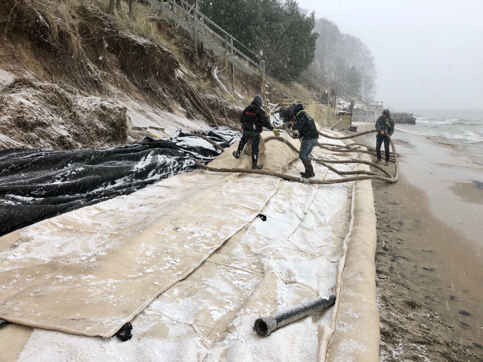 installing sandbags on lake michigan