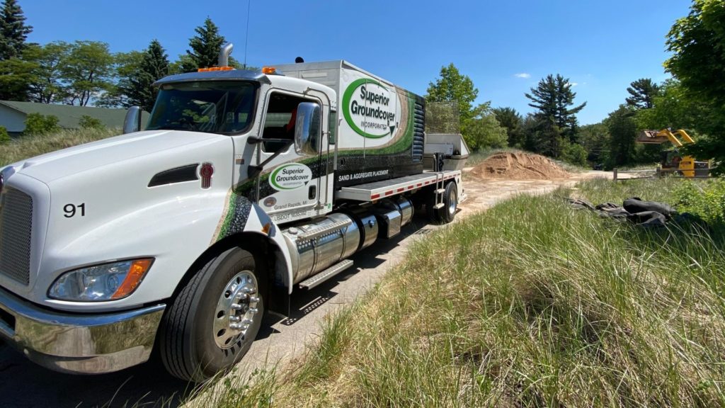 superior groundcover truck bringing sand to an eroded beach