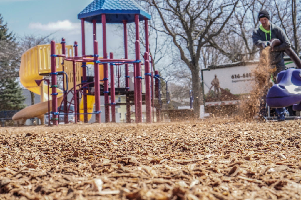 mulch being installed on a playground