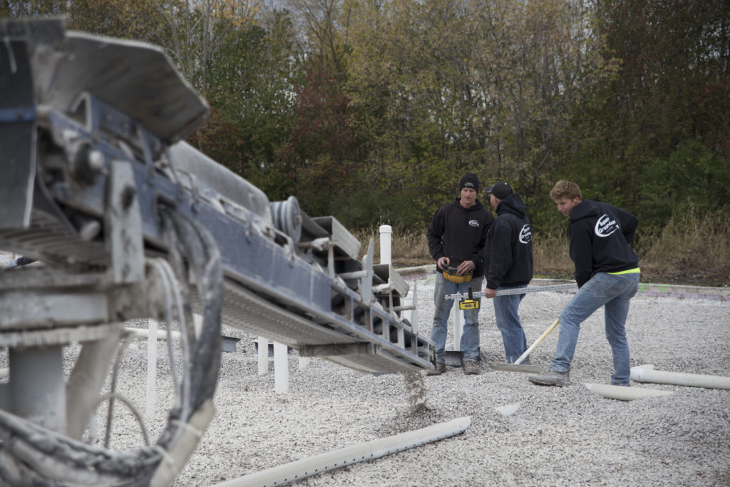 Superior Groundcover team working with a stone slinger truck