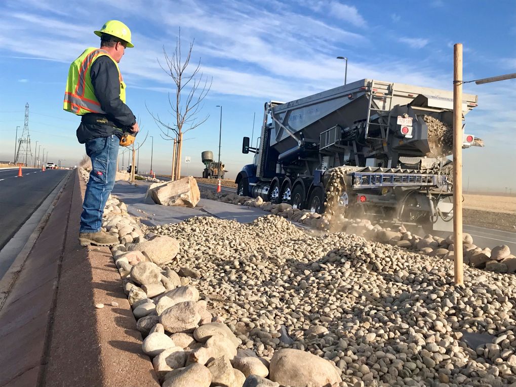 Stone backwall being laid by a worker