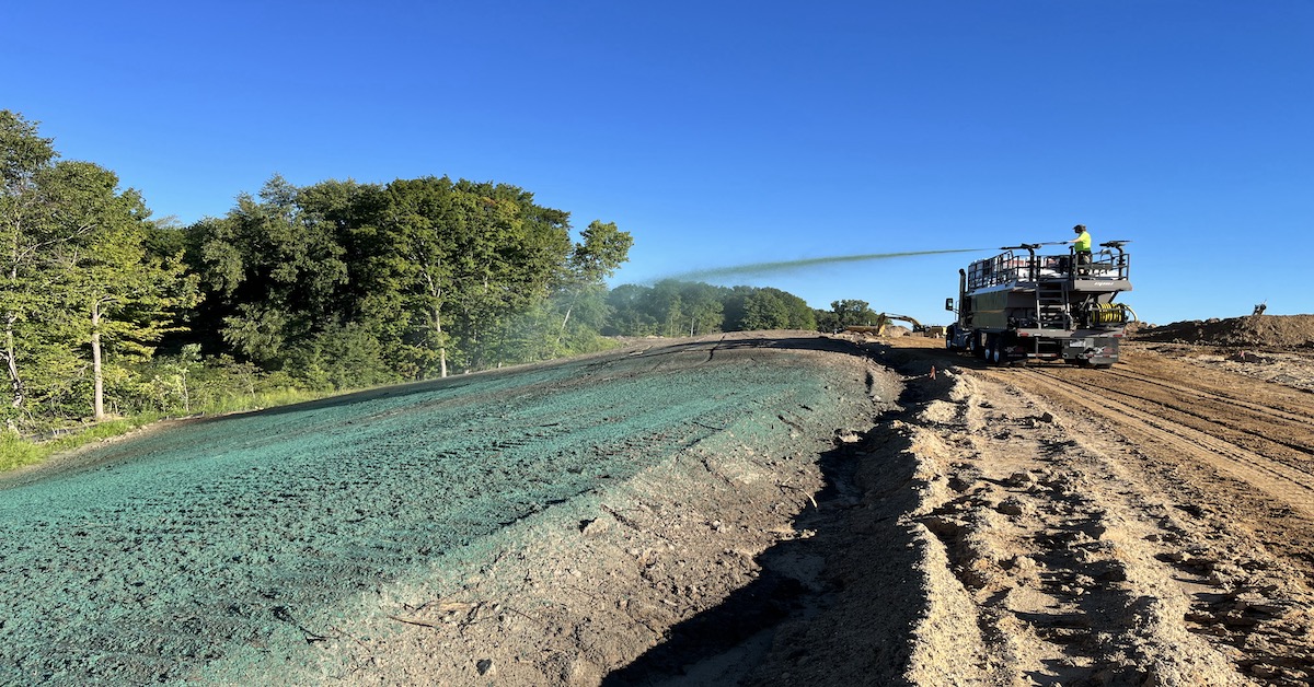 Hydromulch truck spraying green hydromulch