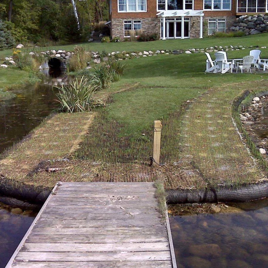 Compost Filter Socks around shore outcropping