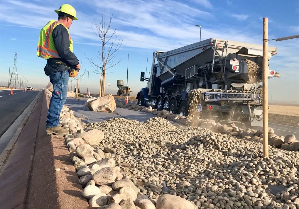 Stone backwall being laid by a worker